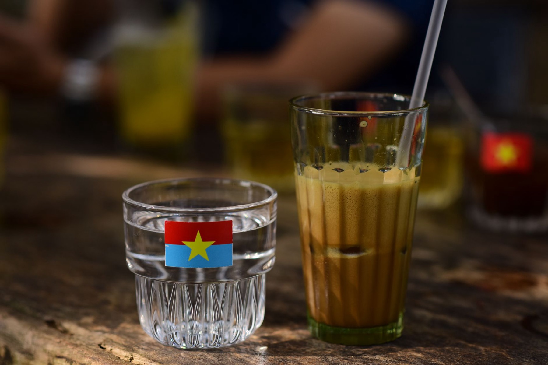 Buon Ma Thuot — Chilled Vietnamese coffee served with a glass of water on a rustic table.