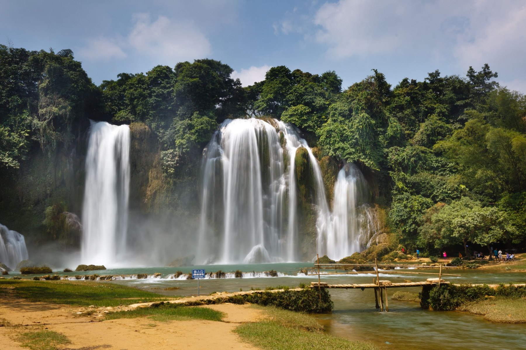 Cao Bang — Breathtaking view of a waterfall cascading through a lush rainforest, showcasing