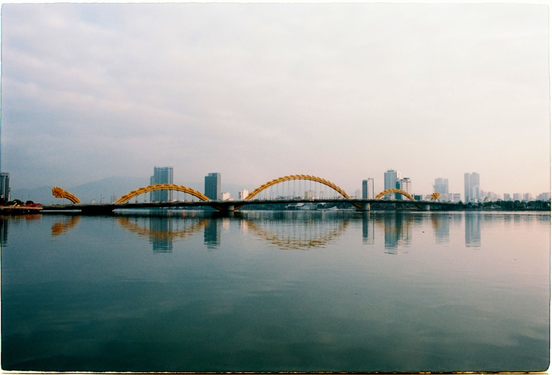 Da Nang — Captivating vista of the iconic Dragon Bridge in Đà Nẵng, reflecting over the tr