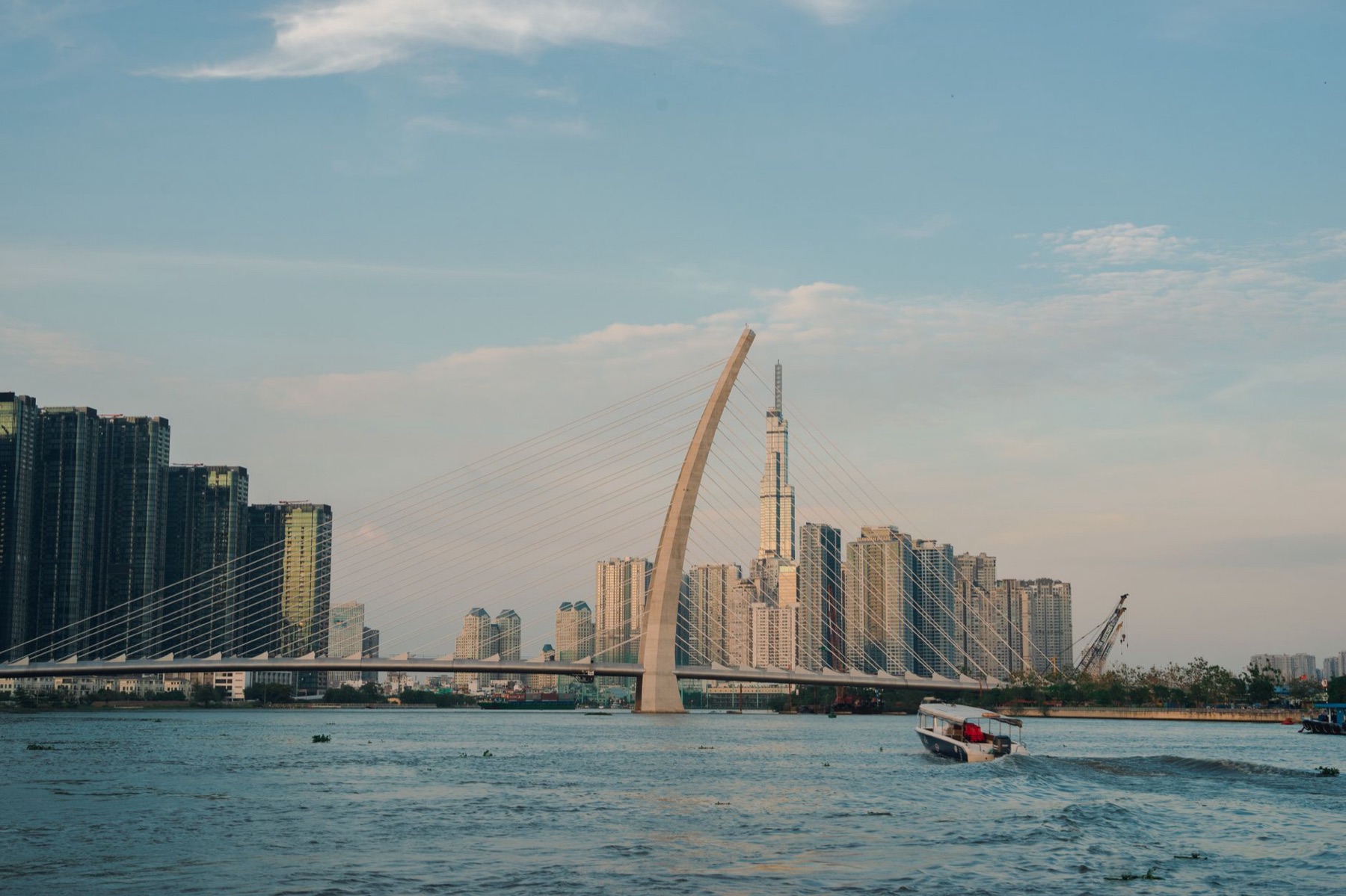 Ho Chi Minh City — View of modern Ho Chi Minh City skyline featuring a prominent bridge and river s