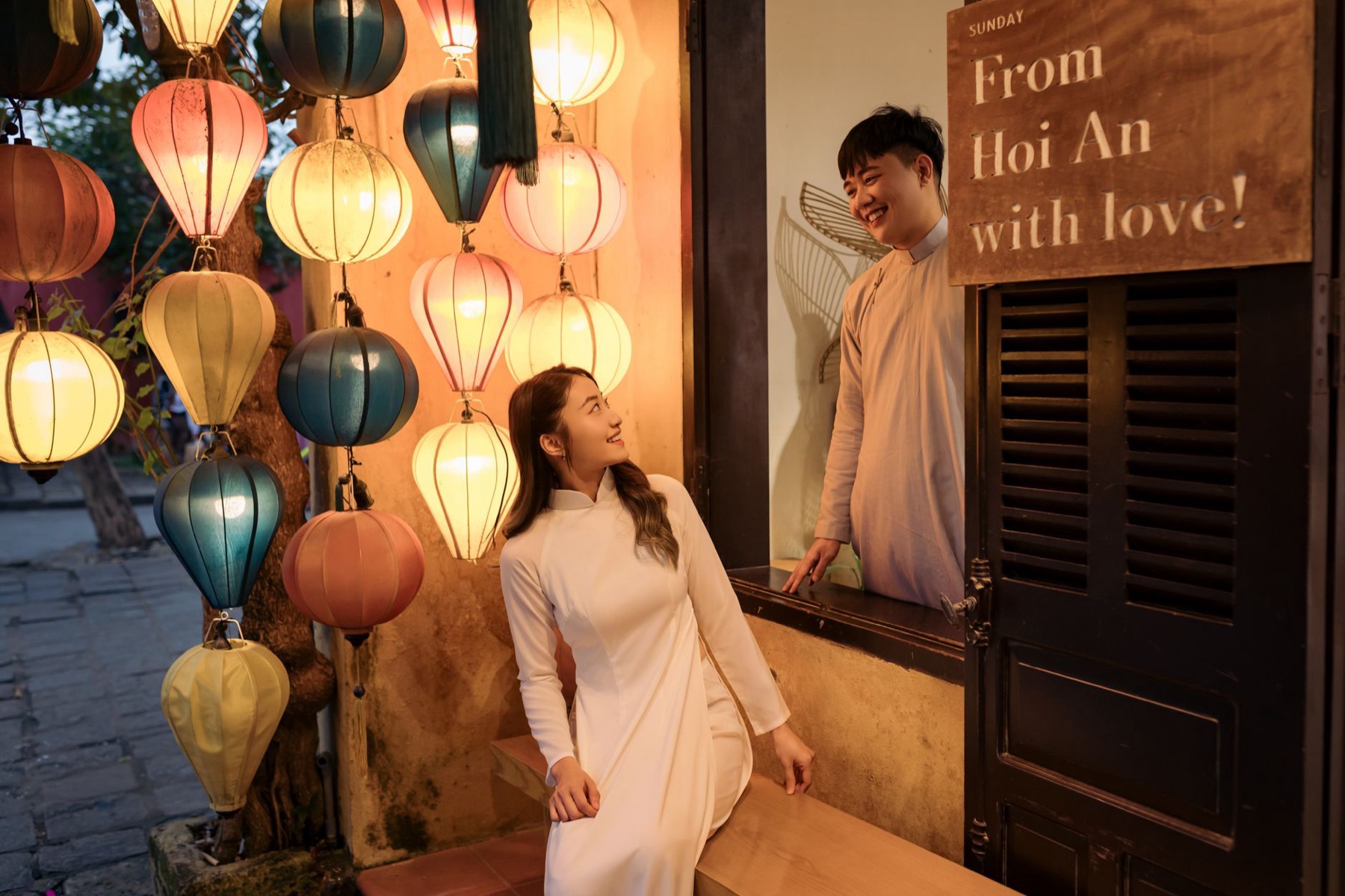 Hoi An — Charming couple sharing a moment in Hội An, surrounded by colorful lanterns at n
