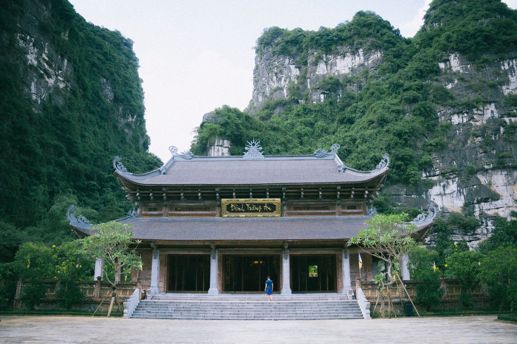 Ninh Binh — A serene view of a traditional pagoda in Ninh Bình, surrounded by lush green hil