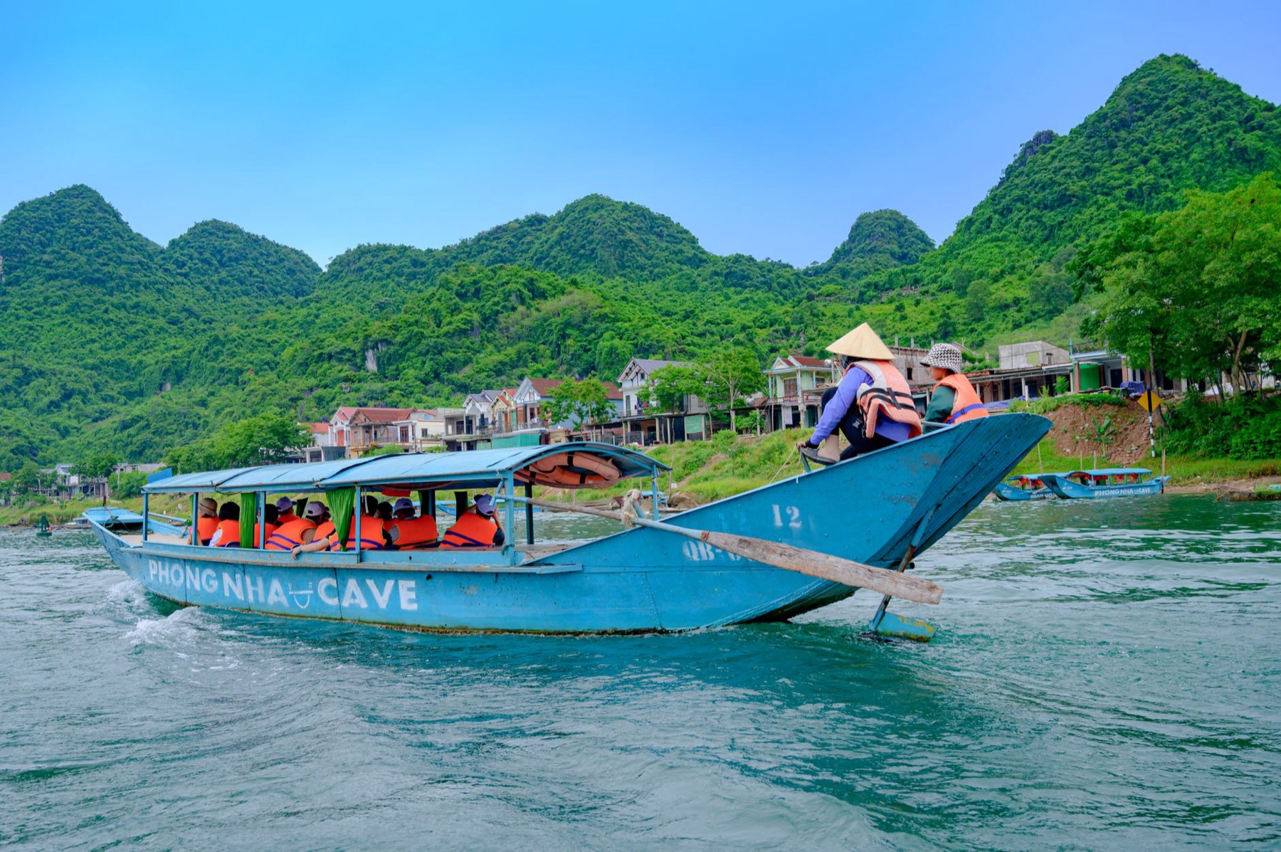 Phong Nha — Tourists enjoy a scenic boat ride in Phong Nha Ke Bang National Park, showcasing